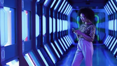 A women looking at her intrusion mobile app in a futuristic setting