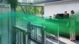 The reception area of an office protected by access control using turnstiles, with the slogan 'Go with the flow'.